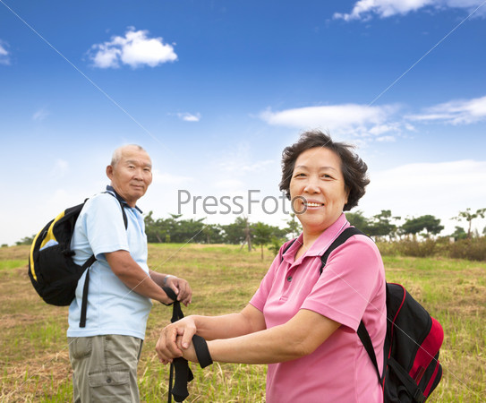 asian Senior couple hiking in countryside