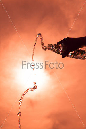 hand holding  bottle water with heat weather background