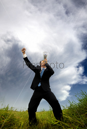 man in the black suit and holding megaphone shouting to the storm