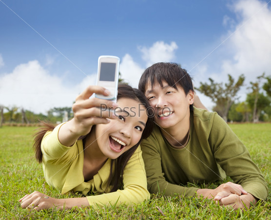 Asian couple taking photo by smart mobile phone