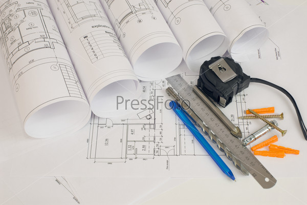 Construction drawings, tape measure, ruler, drills, pen and screws. Desk builder