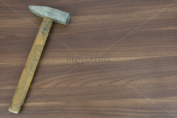 Old hammer on a wooden surface. carpenter tools