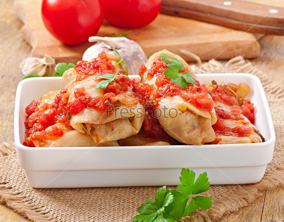 Stuffed cabbage with tomato sauce decorated with parsley
