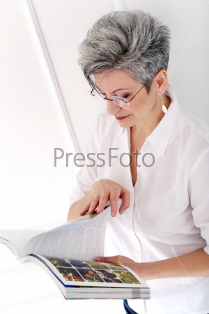 Elderly Happy woman with magazine