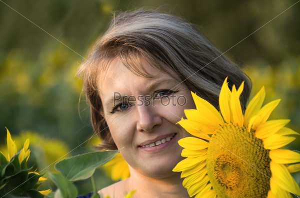 Portrait of adult caucasian woman with bob cut hair in sunflowers