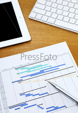 Project planning gantt chart with tablet and computer keyboard