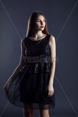 Portrait of beautiful slim model in cocktail dress