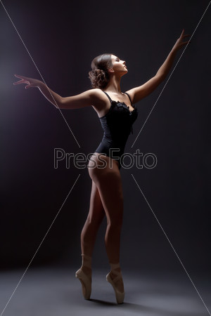 Inspired sexy slim woman dancing on pointes