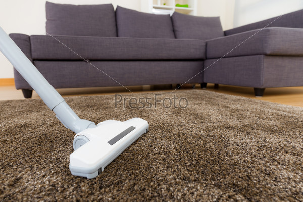 Carpet with vacuum cleaner in living room