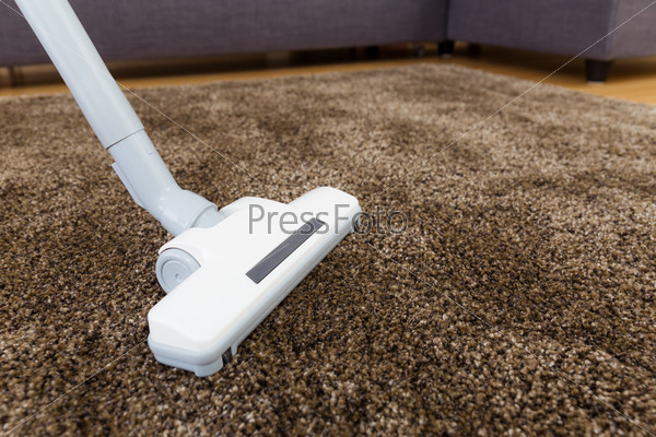 Brown carpet with vacuum cleaner in living room