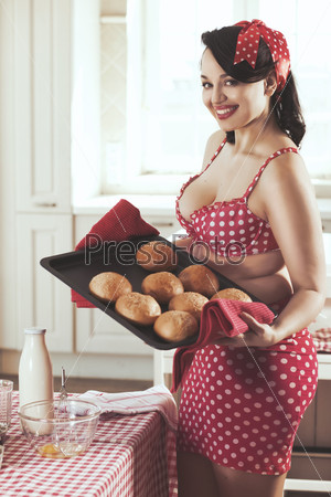 Vintage retro photo of pin up girl in the kitchen at house