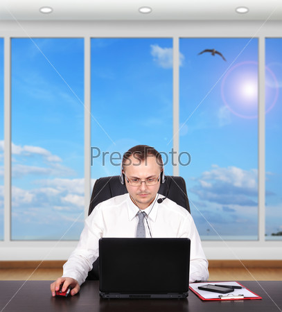 customer service representative sitting in office with laptop