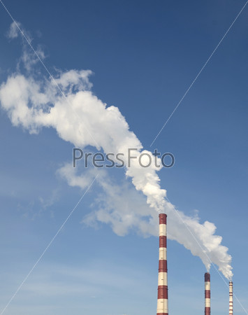 industrial smoke from chimney on blue sky