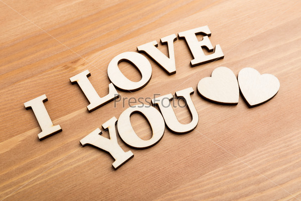 Wooden texture letters forming with phrase I Love You