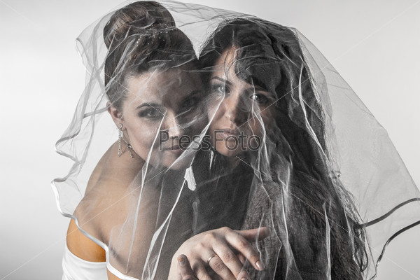 Girlfriends under veil - isolated photo portrait of two happy girls
