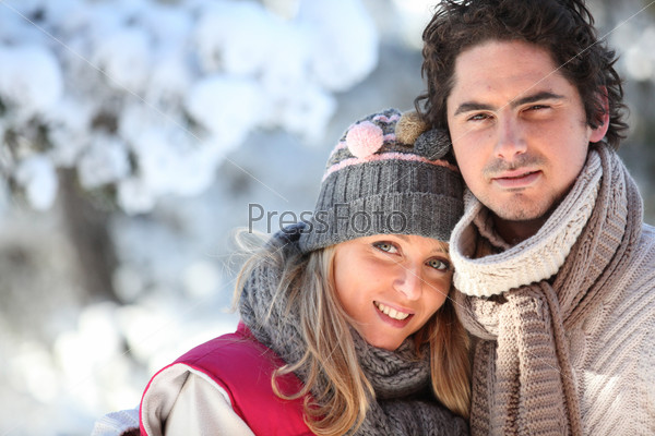 Portrait of a young couple at the snow