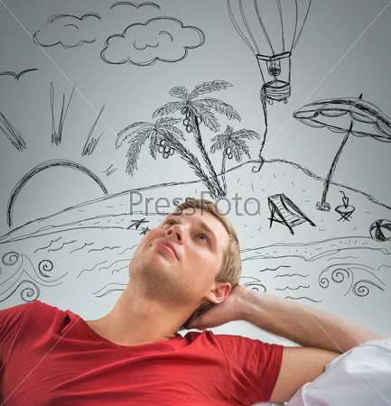 Young man dreaming about his summer vacation on tropical island