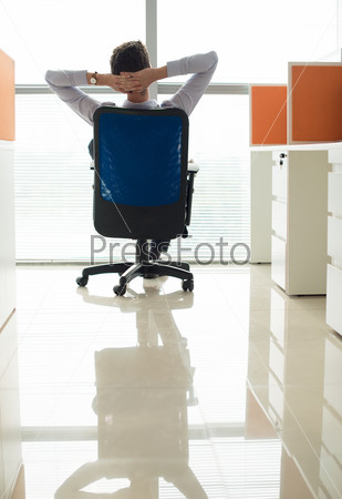 Manager resting on his office chair