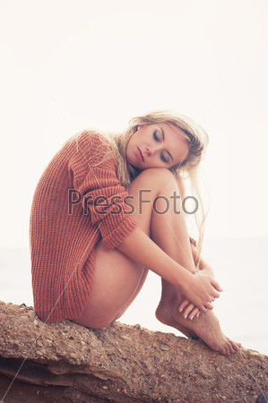 Happy young girl poses on a beach