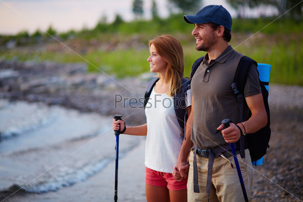 Portrait of couple of happy hikers on a trip