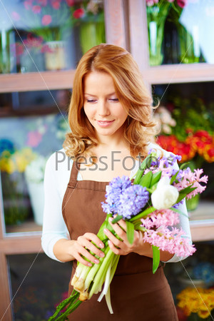 Portrait of young female holding bunch of hyacinths