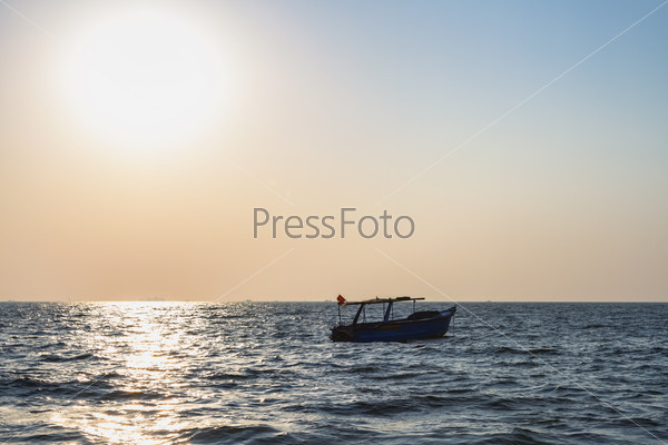 Fishermans boat at Arabian sea. Sun over sea