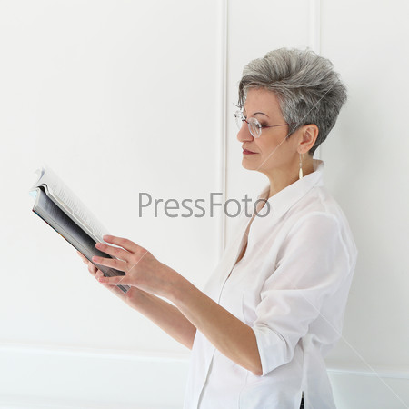 Elderly. Happy woman with magazine