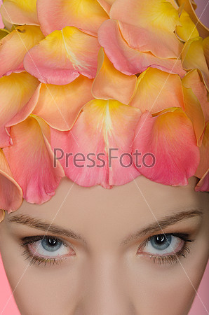 Young woman with rose petals on the head