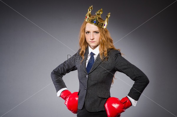 Woman boxer with crown and red gloves, stock photo