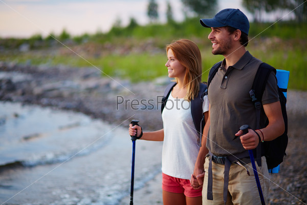 Portrait of couple of happy hikers on a trip