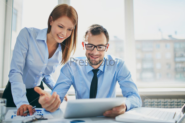 Image of two successful business partners working at meeting in office