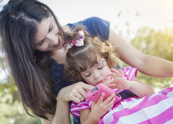 Mother and Cute Baby Daughter Playing with Cell Phone