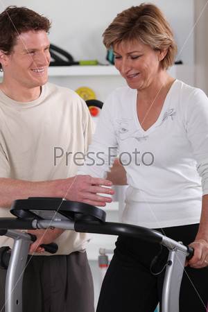 Middle-aged woman doing indoor sport, stock photo