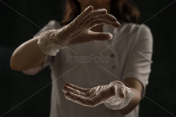 Close up of unrecognizable female doctor holding something in her hands