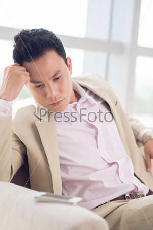 Vietnamese young man waiting for phone call