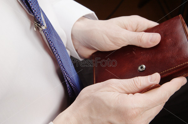Businessman\'s hands holding leather wallet and pen