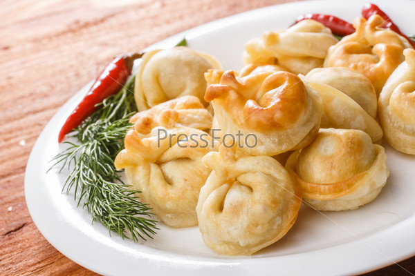 Fried dumplings. Russian pelmeni with meat on a plate. Hearty and tasty  dinner.