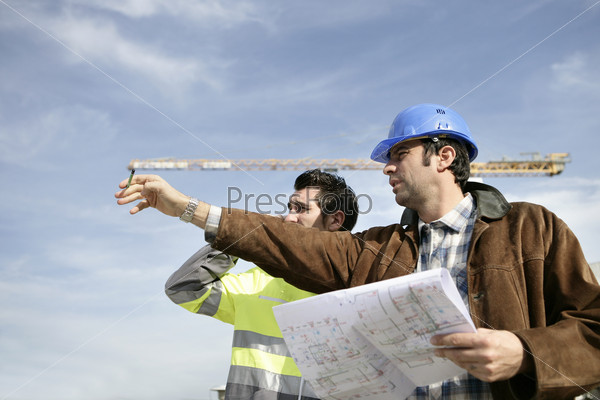 Foreman and worker on a site, stock photo