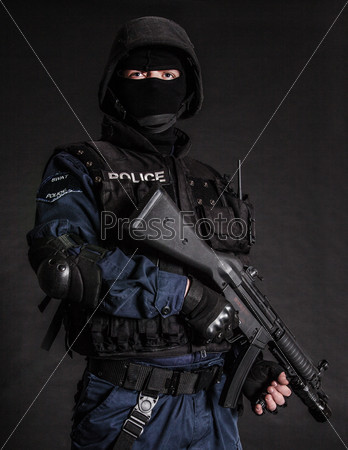 Special weapons and tactics SWAT team officer on black background