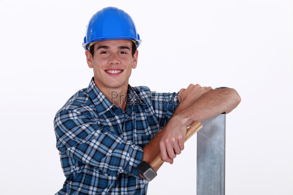 Builder with hammer and sheet of metal
