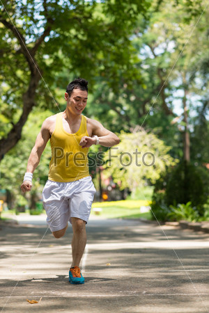 Jogger looking at heart rate monitor on his hand