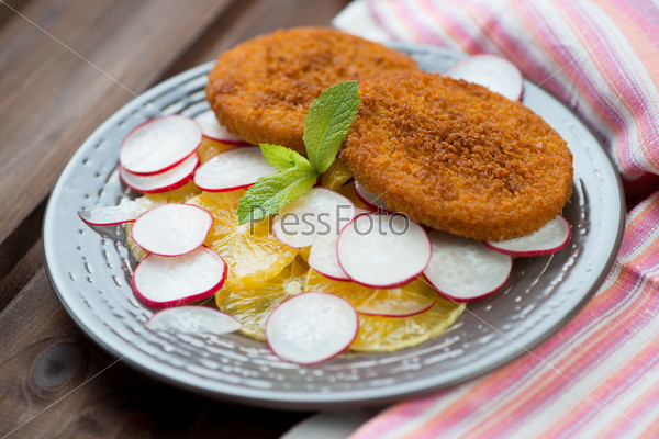 Roasted fish burgers with oranges and radish, horizontal shot