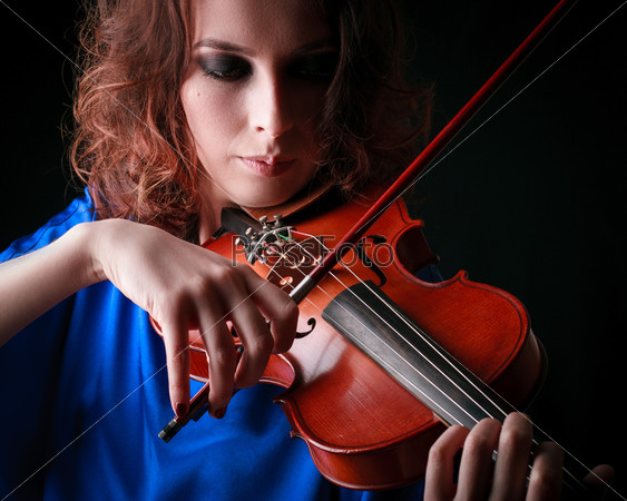 Violin playing violinist musician. Woman classical musical instrument player on black