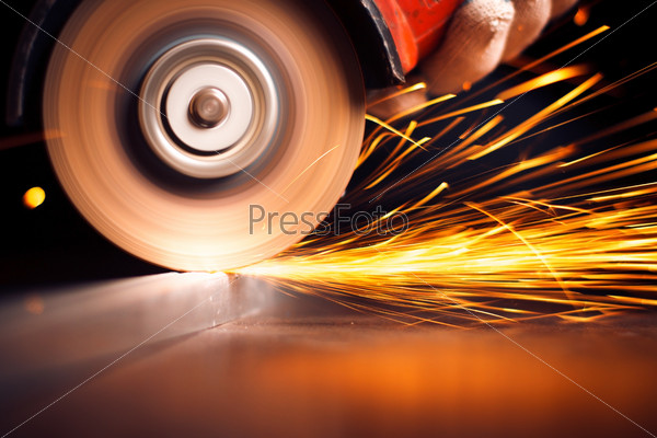Red hot sparks at grinding steel material