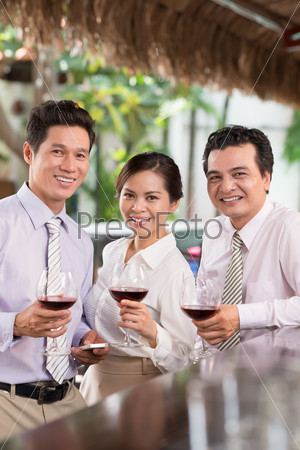 Portrait of three colleagues toasting