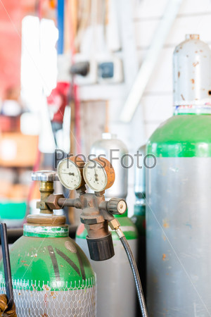 Workshop with welder oxyacetylene gas bottle with pressure measuring device for welding unit, stock photo