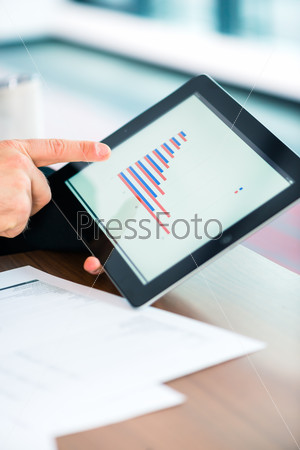 Business - banker, Manager or expert evaluates the figures on tablet computer and compares the development of the business in real time to quickly and efficient advise and act as consultant