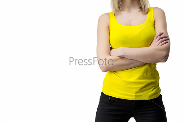 Woman in yellow T-shirt with arms crossed - isolated photo