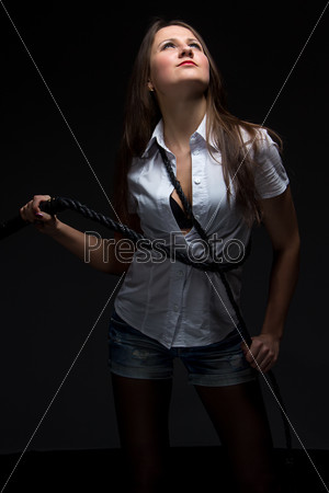 Woman in shadow with whip - isolated photo