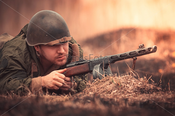 Young man in Red Army form posing with the PPSh-41 (Soviet submachine gun)